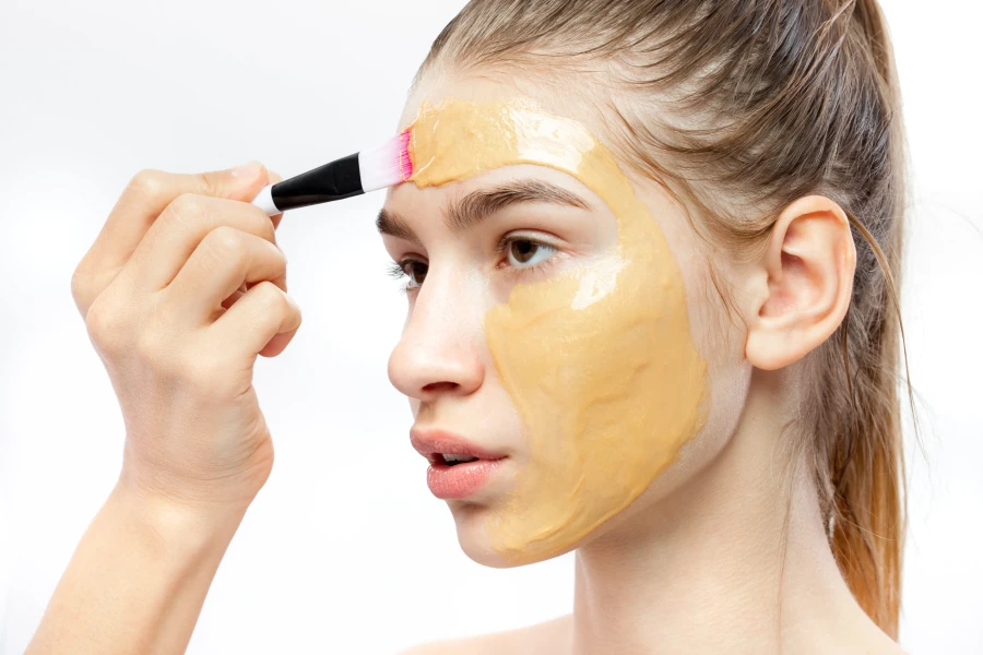 the process of applying yellow cosmetic mask with 2021 08 30 20 01 25 utc